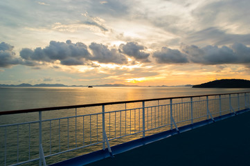 Railing from cruise ship with sunset background