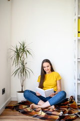 A young woman is reading a book