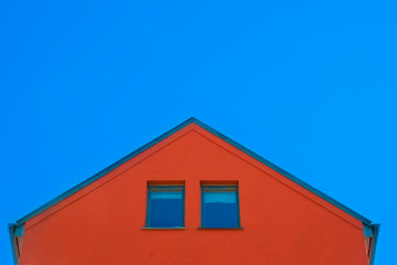 Red plaster facade of the house