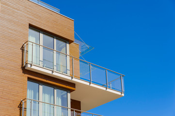 Modern residential building with huge terrace and wooden facade elements