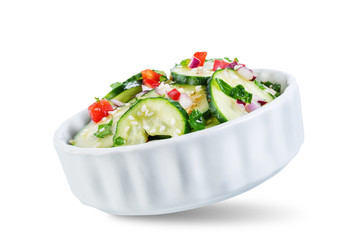 Cucumber spice salad with red onion nd red pepper on a white isolated background