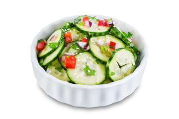 Cucumber spice salad with red onion nd red pepper on a white isolated background