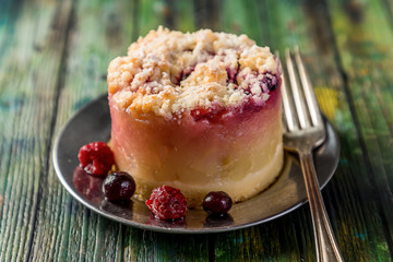 mini red berry cake on green wooden table