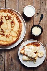 Thin pancakes, crepes with bananas and condensed milk.