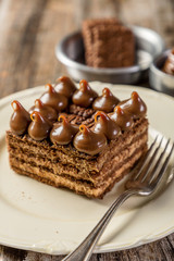portion of chocolinas cake in white plate on wood