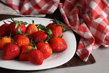 Strawberry berries on a white saucer