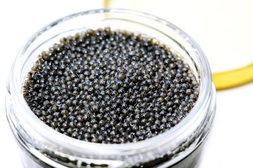 Black sturgeon caviar on a white background.