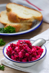 Traditional Russian lean vegetable salad vinaigrette in an iron bowl.