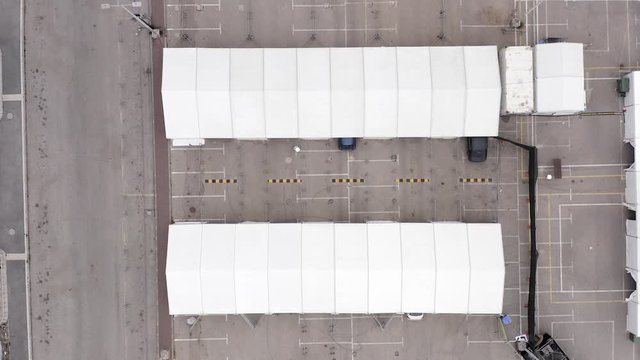 Corona Virus Testing Drive Through Used For Sample Collecting And Fever And Symptoms Check, With Cars Approaching And Leaving, Top Down Aerial View.