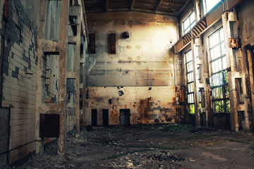 Large abandoned industrial hall. Dangerous area. Abandoned industrial interior with bright lights. Exclusion zone, radiation risk, lost city, apocalyptic building.