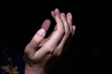Close up of women hand praying at night 