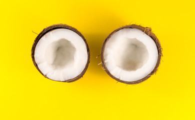 .two half coconut on a yellow background