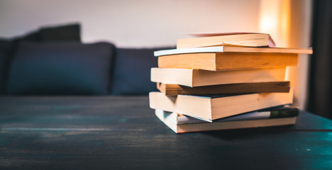 Stack of books lying on a grey table