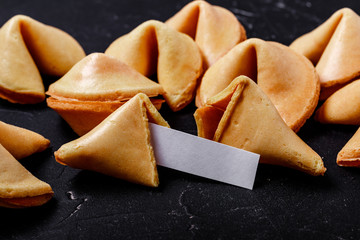 Fortune cookies on a black background, close-up.
