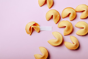 Fortune cookies on a pink background, close-up.