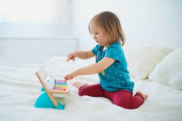 Girl playing toy piano at home