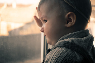 Cutie little baby girl looking out the window