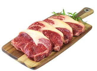 raw meat on a cutting board isolated on white