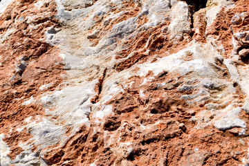 Rough untreated stone surface of marble beige color texture with clay
