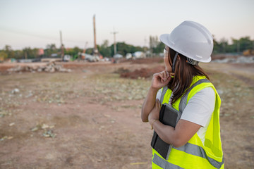 Asian engineer working at site of a large building project,Thailand people,Work overtime at construction site