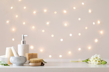 Obraz na płótnie Canvas Spa set on light bokeh backdrop. Healthy lifestyle. Bathroom or spa salon interior. Wellness treatment.