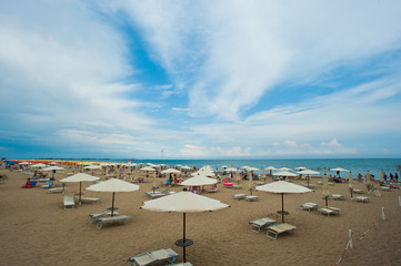 Fototapeta na wymiar Umbrellas on the beach of Lignano Sabbiadoro, one of the most famous beaches of Friuli Venezia Giulia in northeastern Italy. Italy
