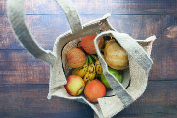  shopping bag with vegetables and fruits on table 