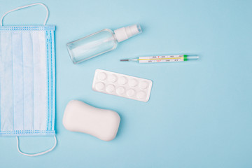 Save yourself. Top above overhead flat lay photo of surgical mask soap blister mercury thermometer and little bottle with spray for hands isolated over background with empty blank copy space