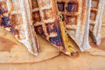 toasted cheese sandwich on a bread board