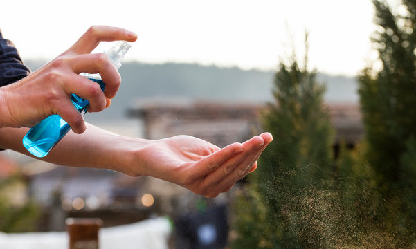 spraying hand sanitizer coronavirus prevention