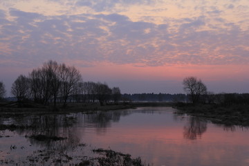 Fototapeta na wymiar Colourful morning over the river flood