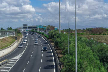 Rome, Italy Italian highway traffic elevated day view. Cars on multi lane road over the outskirts of the Italian capital with signs directions to various cities.
