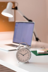 Workplace with alarm clock in modern style. Business communication concept. Home office workplace.