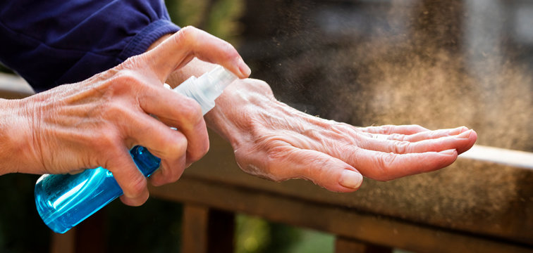spraying hand sanitizer coronavirus prevention