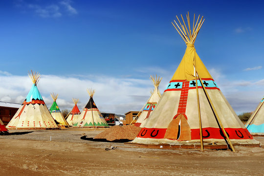 Indian tepee tents in desert landscape