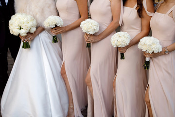 Bridesmaids holding bouquets during wedding ceremony. Wedding decor