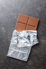 Wrapped chocolate bar in aluminum foil.
