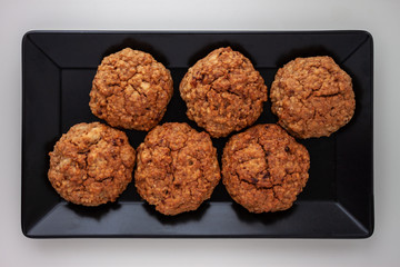 homemade baked oat cookies on black plate