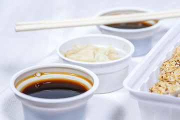 soy sauce in a disposable bowl on a white background