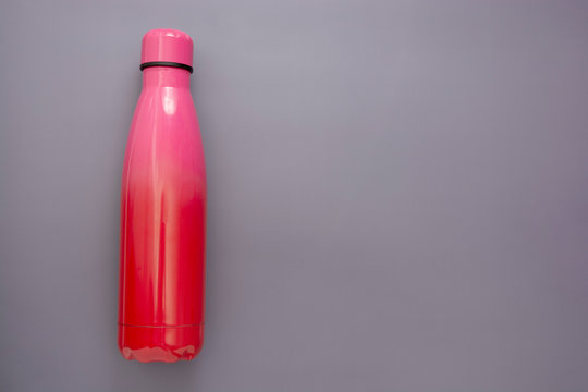 Reusable Water Bottle Over Grey Background, Drinking Water.