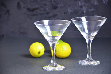 two empty glasses for making margarita cocktails with lime on a black background Margarita cocktails shot on a bar counter in a nightclub
