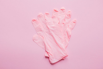 Pink gloves on pink background flat lay. Coronavirus pandemic. Stay safe. Prevention of virus epidemic. Safe shopping and walking outside in quarantine. Stay home safe lives