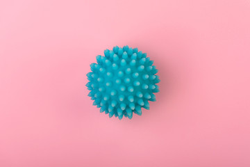 Single abstract virus strain model of coronavirus on pink background.