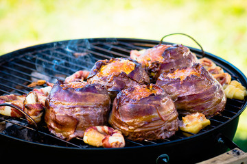 Beer bacon cheese burgers on grill.