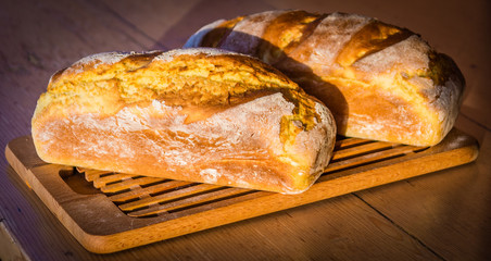 Two home madee bread loafs cooling in the early spring morning day.