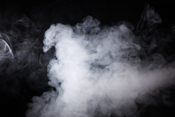 Cloud of white smoke on a black background closeup