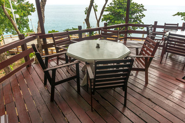 Table and chair at outdoor restaurant facing to ocean