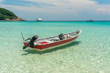 Boat with clear water and blue skies at Perhentian Island, Malaysia