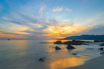 Fototapeta na wymiar Beach rock and sunrise background