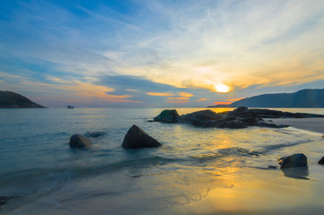 Beach rock and sunrise background